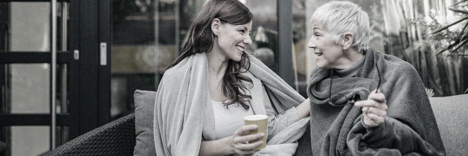 Two Senior women talking on an outdoor bench
